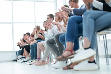 Wall Mural - background image of young people applauding in the conference room