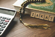 © MohamadFaizal - Concept of zakat in Islam religion. Selective focus of wooden alphabet, calculator, rosary beads and Quran on wooden background.