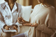 © rogerphoto - Close-up woman-patient holding pills near her doctor, time to take medications, cure for headache or remedy pain killer drugs. Stay at home concept during Coronavirus pandemic and self isolation