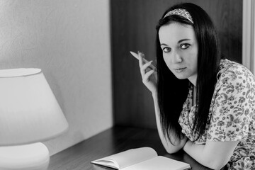 Woman in retro style clothing with a pen and a diary