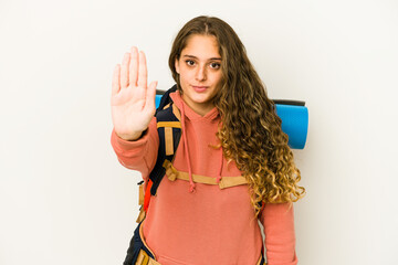 Wall Mural - Young caucasian woman ready for a trip isolated standing with outstretched hand showing stop sign, preventing you.