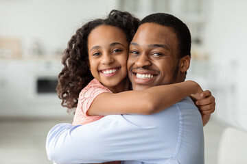 Sticker - Cute african american school girl hugging her cheerful dad