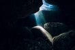 Underwater rocky cave in ocean with sun rays