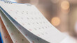 © Kwangmoozaa - Close up white paper desk calendar with blurred bokeh background appointment and business meeting concept