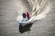 Prague, Czech republic - February 24, 2021. Speed white dinghy boat with two man on board in Winter