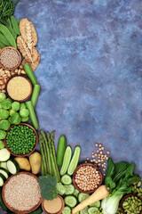 Wall Mural - High fibre green and yellow food for gut health with fruit, vegetables and grain products on mottled blue. Also high in antioxidants, protein, omega 3, smart carbs, vitamins and minerals 