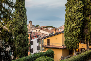 Wall Mural - View of Lake Garda and the roofs of the houses in Desenzano. A clear autumn evening. Desenzano, Verona, Italy