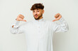 © Asier - Young Moroccan man wearing a typical arab clothes isolated on white background feels proud and self confident, example to follow.