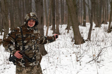 A soldier with hand grenade in the snowy forest