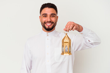 Young handsome arab man holding a lamp