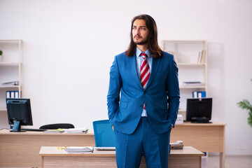 Young male employee working at workplace