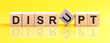 disrupt word is made of wooden building blocks lying on the yellow table, concept