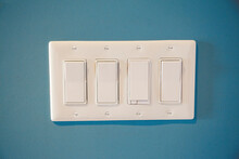 Four Rocker Panel Light Switches On The Wall