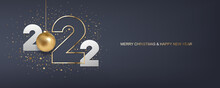 Happy New Year 2022. White Paper Numbers And Golden Christmas Ball With Confetti On Dark Blue Background. Holiday Greeting Card Design.