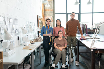 Poster - Team of successful contemporary fashion designers and tailors in casualwear standing in workshop