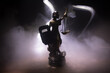 Law concept. Miniature colorful artwork decoration with fog and backlight. The Statue of Justice - lady justice or Iustitia Justitia the Roman goddess of Justice. Selective focus