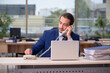 © Elnur - Young male employee working in the office