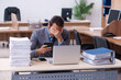 © Elnur - Young male employee unhappy with excessive work in the office
