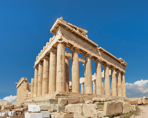 Fototapete - Acropolis, ancient Greek fortress in Athens, Greece. Panoramic image of Parthenon temple on a bright day with blue sky and faraway clouds. Classical Greek heritage