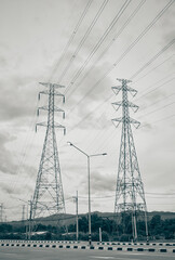 Portrait Two High Voltage Tower or High Voltage Post Beside The Road and Sky Background with Natural Green Tree in Vintage Tone