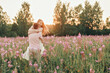 © aaalll3110 - a couple in love walks through a flower meadow. Love and spring blooming. a man embraces a woman