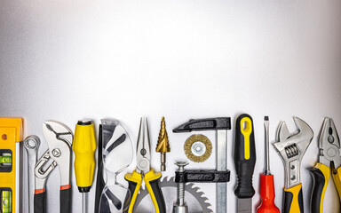 Wall Mural - different work tools on gray metal surface. view from above. industrial background