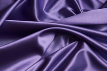 Purple Silk Fabric Background, Close-up. Smooth Violet Satin Cloth Texture