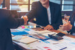 © aFotostock - Team Business Partners shaking hands together to Greeting Start up small business in meeting room. Shakehand teamwork partners at modern office handshake together. Business mergers and acquisitions