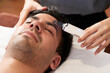 © DragonImages - Young man getting face skin scrubber treatment with ultrasonic spatula in beauty salon