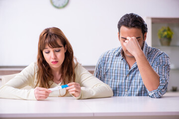 Young couple in unexpected pregnancy concept at home