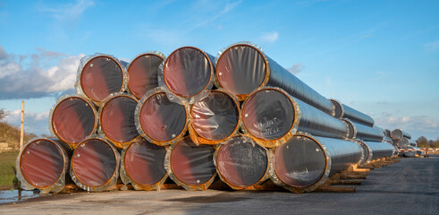 A stack of pipes on the construction site of a gas pipeline that will be laid on the seabed