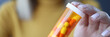 Woman holding jar of capsules in her hands closeup