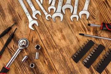 Set of different working tools on wooden background