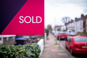 Wall Mural - Estate agent SOLD sign on street of houses