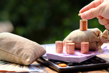 Wall Mural - stack of coin with calculator on table background and saving money and business growth concept,finance and investment concept