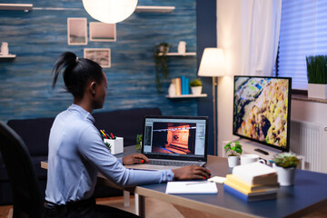 Young african woman gamer testing online professional game on laptop at home late at night. Professional player checking digital video games on her computer with modern technology network wireless.