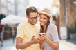 © Kalim - Happy tourists sightseeing during summer holidays