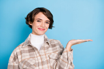 Poster - Photo of optimistic nice short hairdo lady hold empty space wear white shirt isolated on vivid teal color background