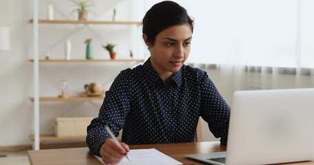 Canvas Print - Pensive young indian female worker thinking on task, web surfing information online. Concentrated smart millennial multiracial woman studying distantly using electronic sources, preparing for exam.