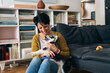 © cherryandbees - woman relaxing at home with her puppy husky