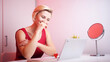 © CameraCraft - Online dating. Young woman in red dress having online date on Valentines day. High quality photo