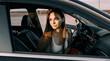 © Daria Lukoiko - Beautiful young girl driving a car in the evening in the sunset sun on an empty parking lot