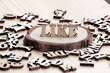 © shawnfighterlin - LIKE written with wooden letters decorated on pine wooden chip decoration.