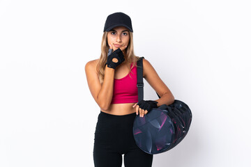 Wall Mural - Young sport woman with sport bag over isolated white background thinking