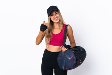 Wall Mural - Young sport woman with sport bag over isolated white background making money gesture