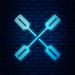 Wall Mural - Glowing neon Paddle icon isolated on brick wall background. Paddle boat oars. Vector