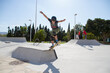 © Jose Prieto - Teenage boy in skateboard park against blue sky