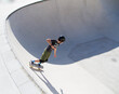 © Jose Prieto - Teenage boy in skateboard park against blue sky
