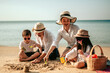 © Garun Studios - Happy parents and kid having fun with playing sand in summer vacation on the beach.Travel,Happy family and vacation concept.