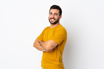 Wall Mural - Young handsome man with beard isolated on white background with arms crossed and looking forward